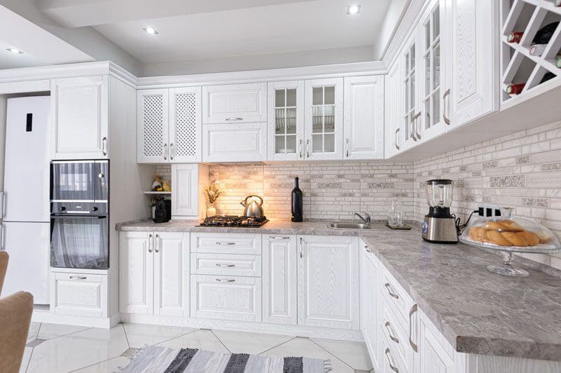Kitchen with white cabinets and granite countertops