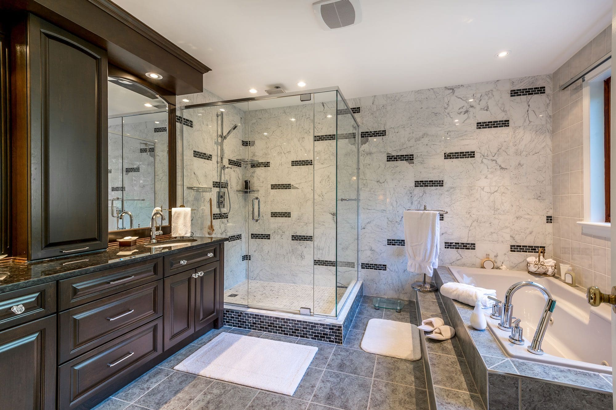 Elegant bathroom with a glass shower and large bath tub